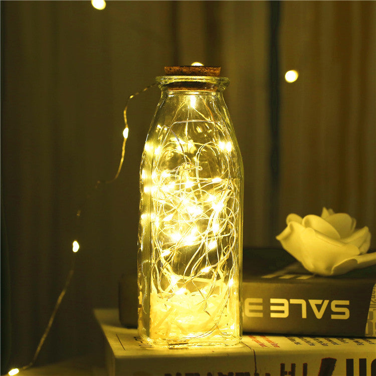 Glass bottle with gypsophila lights